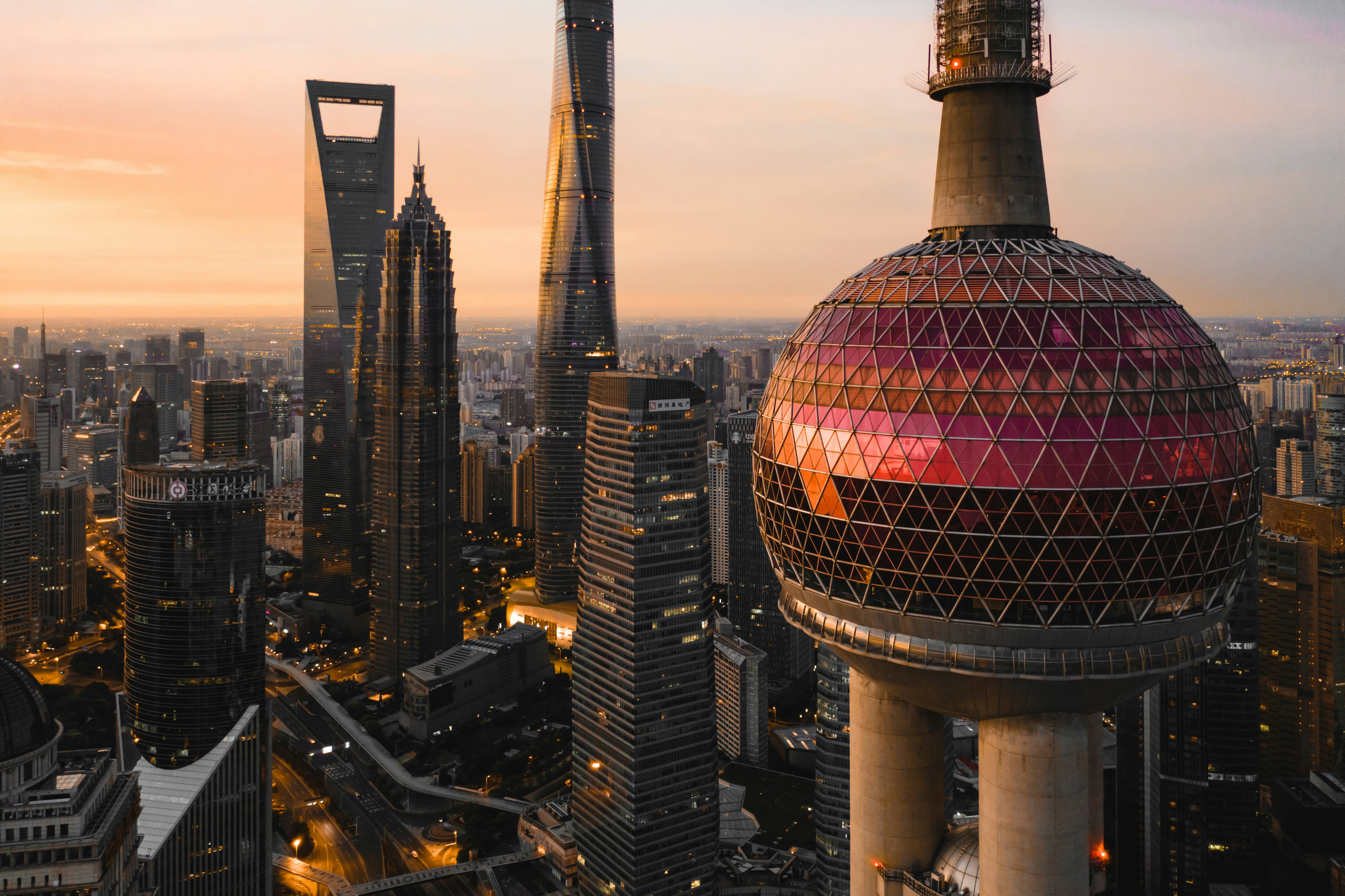 Close-up of Oriental Pearl Tower's pink mid-sphere at sunset, with Jin Mao and Shanghai Tower in the background