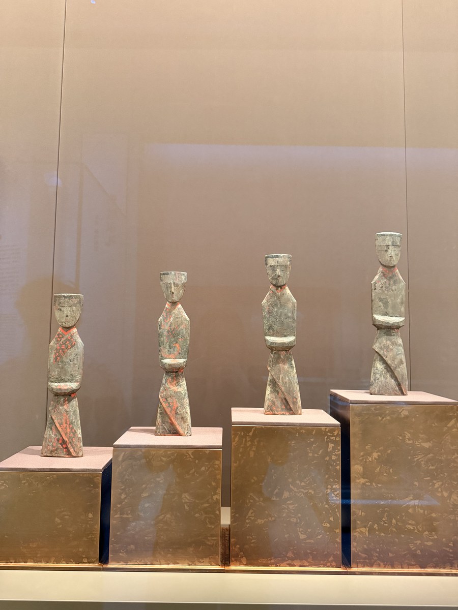 A group of four painted ceramic figurines on cube pedestals in the Sculpture Gallery on the 1st floor