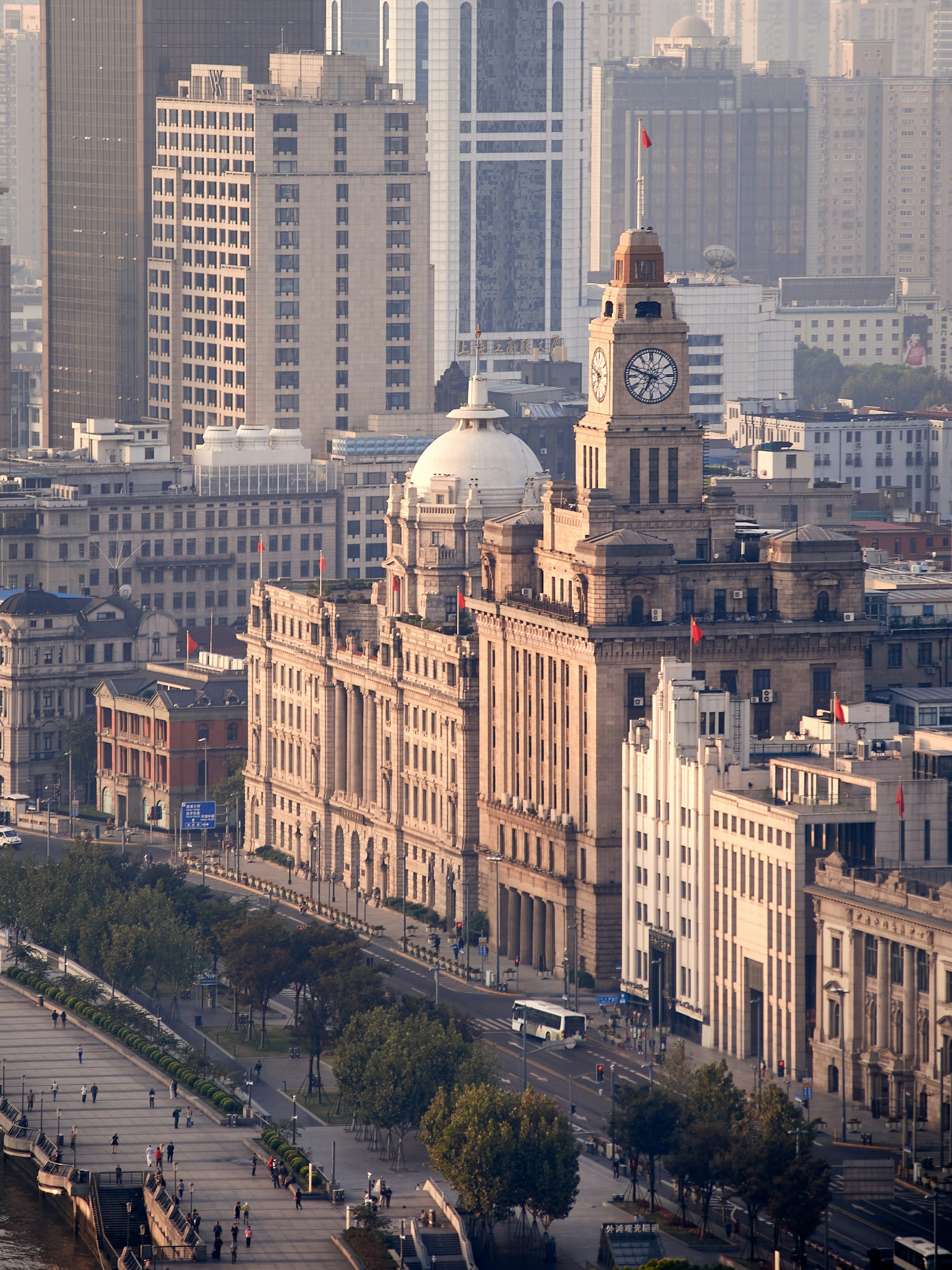 Daytime view of Bund colonial facades with Customs House clock tower and Pudong towers behind