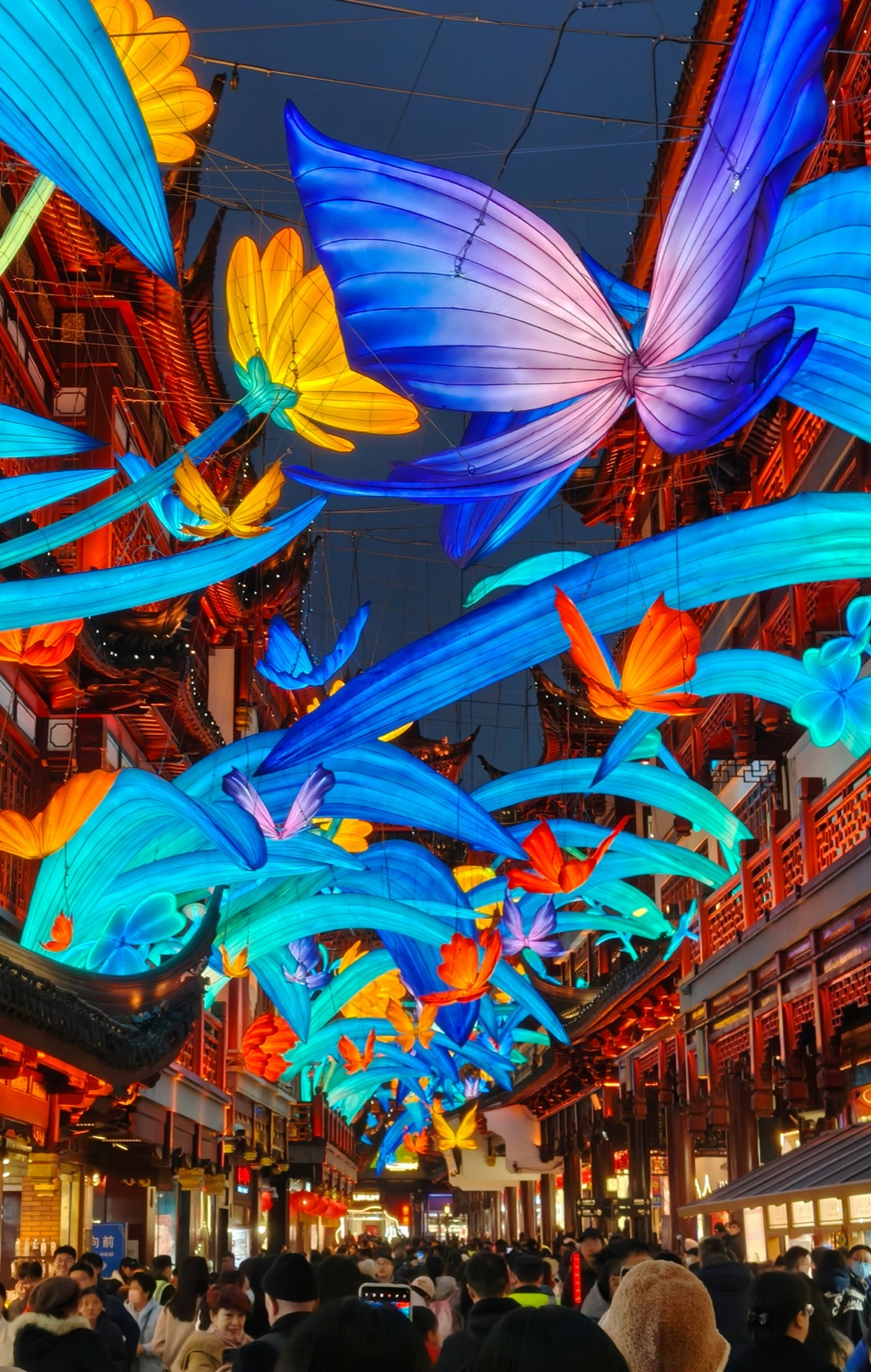 Yu Garden Bazaar during Lantern Festival — large silk butterflies and flowers illuminated overhead at night